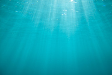 Underwater blue background with sun rays