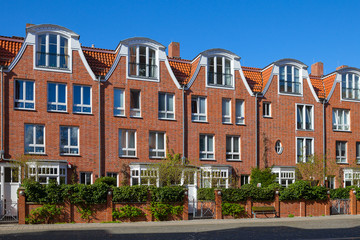 The street with hew red brick residential houses with an old German stylization. Bremen, Germany.