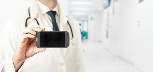 Medicine doctor showing blank screen of a smartphone. Copyspace.