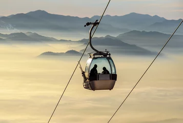 Printed kitchen splashbacks Gondolas Sight on the cable-way infrastructure over foggy valley. Ropeway and cablecar transport system for skiers