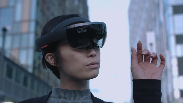 Asian female Using Virtual Reality outside