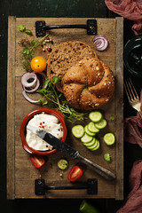 Homemade bread loaf and fresh ingredients for making vegetarian