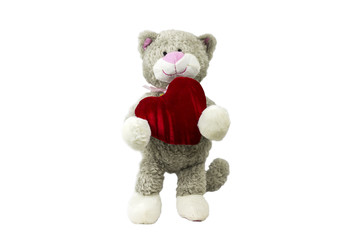 Toy cat is holding a heart on white background.