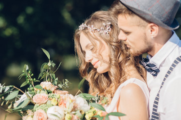 bride and groom hugging at the wedding in nature.