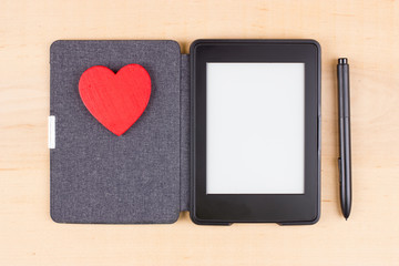 E-book reader with red heart and copy space