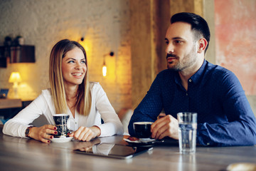 Young businesswoman and man on coffee break in cafe