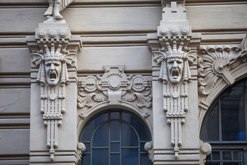 Fototapeta na wymiar An element of facade of an Art Nouveau building with bas-relief and statues. Riga, Latvia.