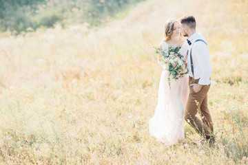 bride and groom hugging at the wedding in nature.