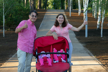 young parents and their two little children in a twin stroller
