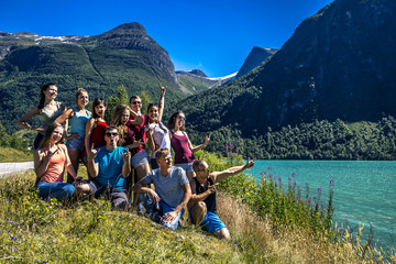 Group of young people standing next to the beautiful lake among - 134377515