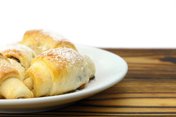 Homemade fresh bagels in plate on wooden and white background.
