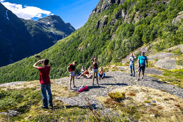 Group of people on the rocks enjoying the sunny day in national