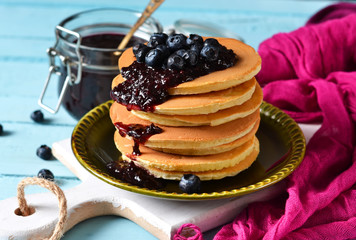 Homemade Pancake with blueberry jam on a blue background