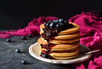 Homemade Pancake with blueberry jam on a black background