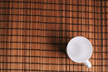 A light cup on a wooden napkin