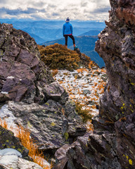 Hiker standing on snow-covered peak in Montana