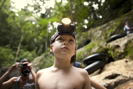 Young boy wearing a headlamp.