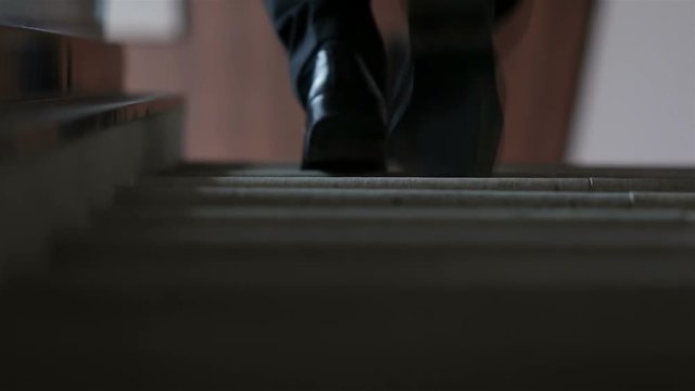closeup of business man walking on stairs