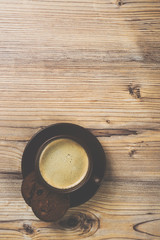 Cup of coffee on wooden vintage board background