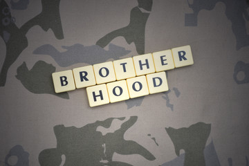 letters with text brotherhood on the khaki background. military concept