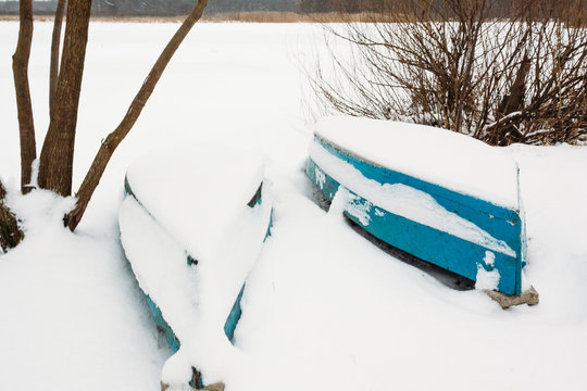 Two boats on the shore in snow