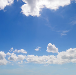 light cumulus clouds in the blue sky