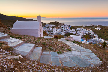 View of Chora on Ios island early in the morning. Santorini island can be seen on the horizon.