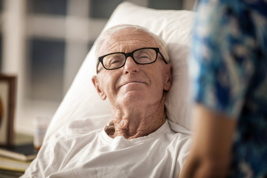 Portrait of an elderly rest home patient in bed.
