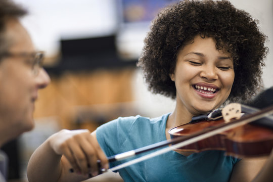 Teenage girl learning to play violin