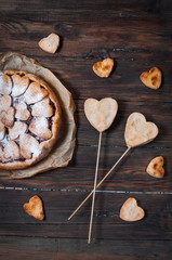 Idea for the celebration of Valentine's Day: cherry pie with the decor  the dough in the shape  heart on wooden table.