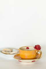 Beautiful handmade orange cup with red rose