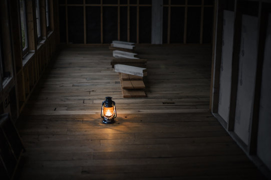 Oil lantern illuminating a cabin under construction.