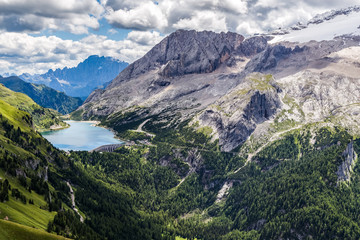 Naklejka na ściany i meble View of the Marmolada, also known as the Queen of the Dolomites and the Fedaia Lake. Marmolada is the highest mountain of the Dolomites, situated in northeast of Italy.