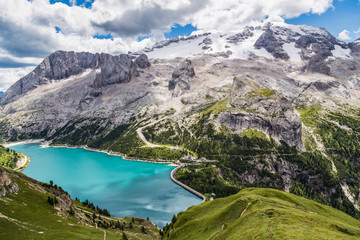Fototapeta na wymiar View of the Marmolada, also known as the Queen of the Dolomites and the Fedaia Lake. Marmolada is the highest mountain of the Dolomites, situated in northeast of Italy.