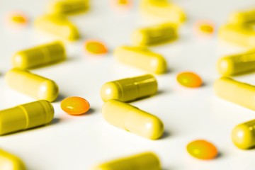 medical pills and capsules pattern on white background. flat lay, top view.