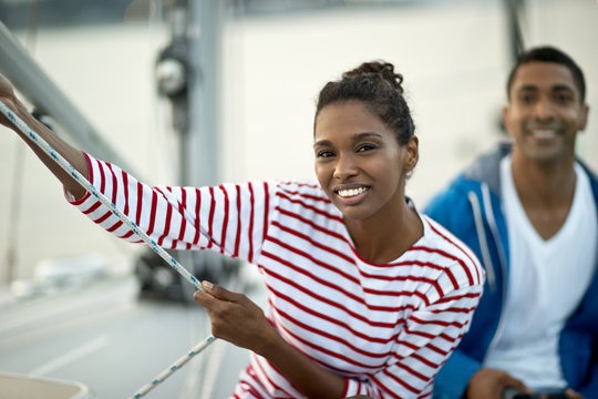 Portrait of a smiling young woman sitting on a boat.