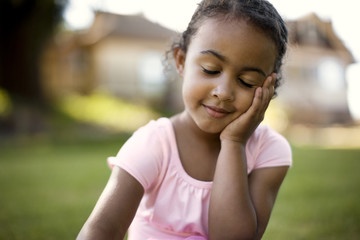 Mid adult woman tying the ribbon on a ballet slipper.