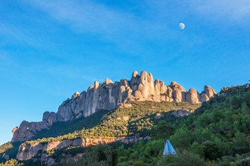 Spain. Barcelona.  Beautiful evening view of the mountains of Montserrat. Multi-peaked rocky range - obrazy, fototapety, plakaty