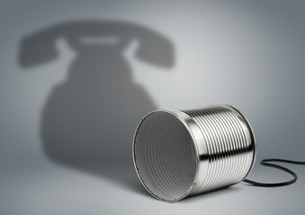 Tin can with telephone shadow, communication creative concept