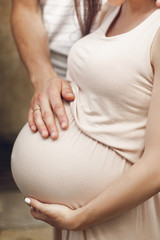 husband holding and hugging big belly bump of his pregnant styli