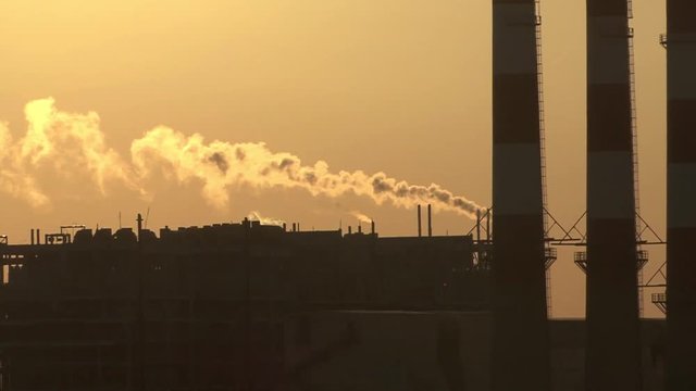 Industrial power plant at sunset