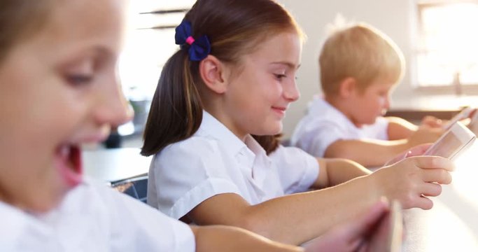 School kids using digital tablet in classroom at school 4k
