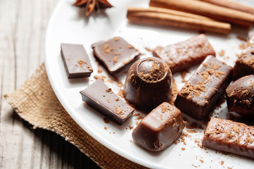 Pieces of chocolate with cinnamon and star anise on table