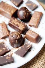 various chocolates as a background - sweet food on dish
