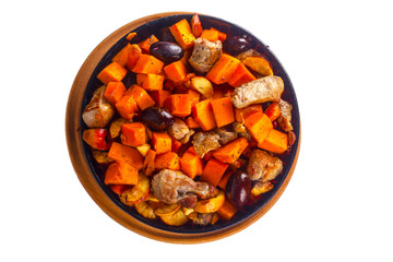 Baked pumpkin with meat, plums in a bowl on a white background