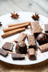 Pieces of chocolate with cinnamon and star anise on table