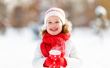 happy child girl with tea on winter.