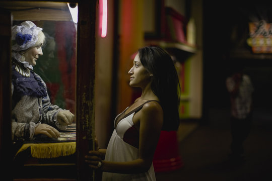 Side view of young woman standing at carnival