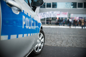 detail of a police (Policja) car in Poland, demonstration in bac