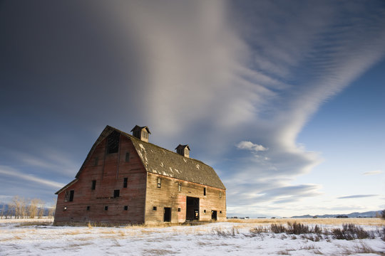 Abandoned barn in a snowy field